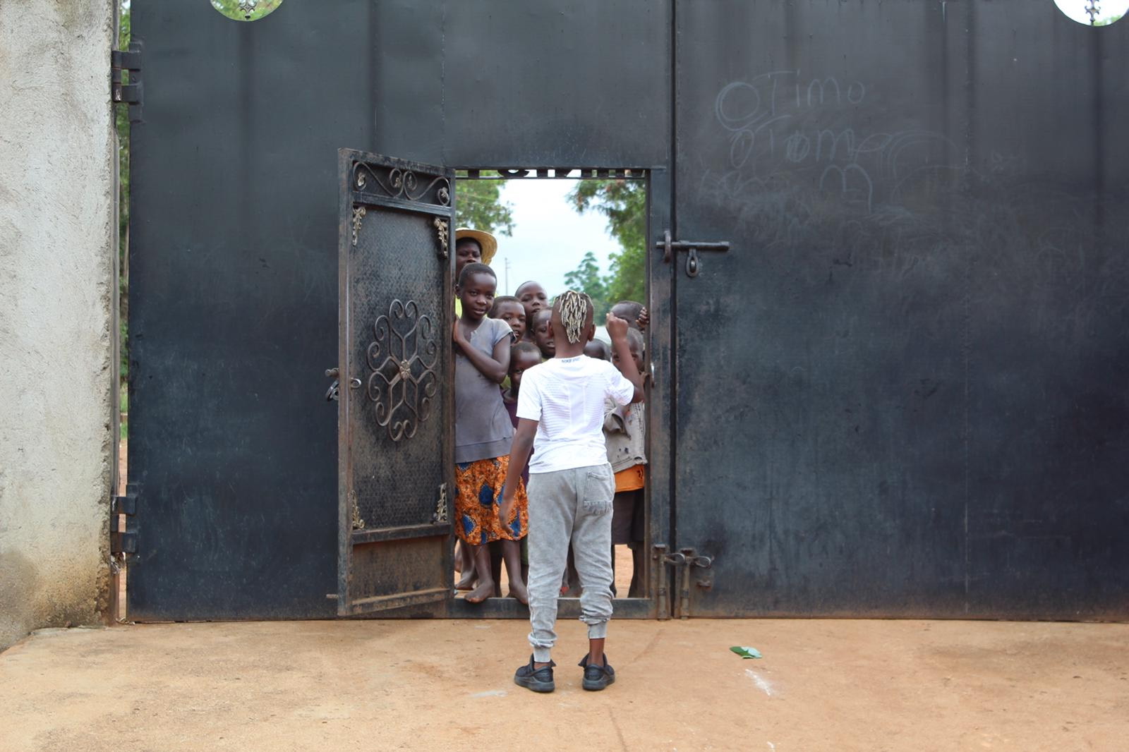 Caleb with children at the Smile Door